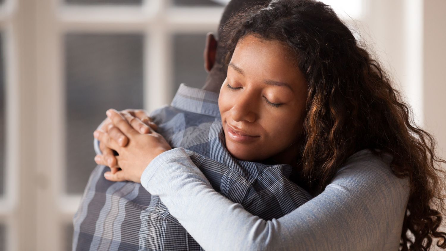 Teenage daughter hugging her father.