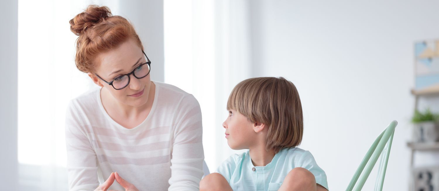 Young boy looking at counselor.